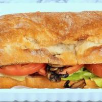 Vegan Burger · Plant Based Burger, Lettuce, Tomato, Mushroom, and hummus on a Ciabatta Bun