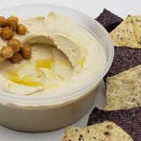 Hummus  · Chickpeas, garlic, tahini lemon olive oil dressing, with tortilla chips