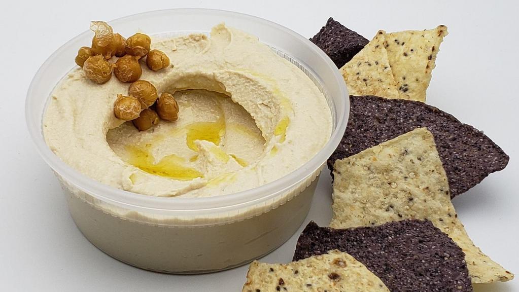 Hummus  · Chickpeas, garlic, tahini lemon olive oil dressing, with tortilla chips