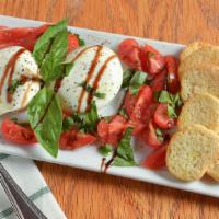 Burrata · Served with fresh basil, heirloom tomatoes, cracked pepper and drizzled with fig balsamic gl...