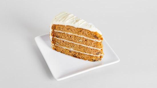 Classic Carrot Cake · Layers of incredibly moist carrot cake studded with raisins, walnuts, and pineapple, topped with a smooth cream cheese frosting.