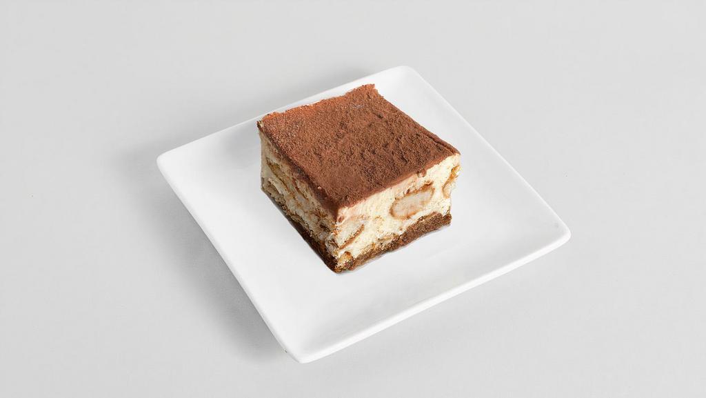 Tiramisu · Made with coffee brandy soaked sponge cake and tapped with clouds of light and soft mascarpone cream, finished with delicious sweet cocoa.