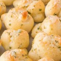 Garlic Knots · Smothered in Garlic, oil,  parmesan cheese