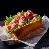 Lobster Roll · 460 Cal. Lobster tossed with lemon tarragon mayo served with emerald greens in a freshly bak...