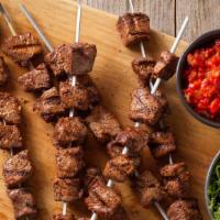 Beef Shish Kebab  · 3 beef skewers comes with rice, salad and white sauce.