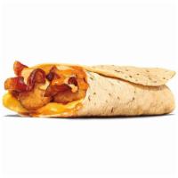 Egg-Normous Burrito™ · Featuring a generous serving of thick-cut smoked bacon, lots of fluffy eggs, topped with Que...
