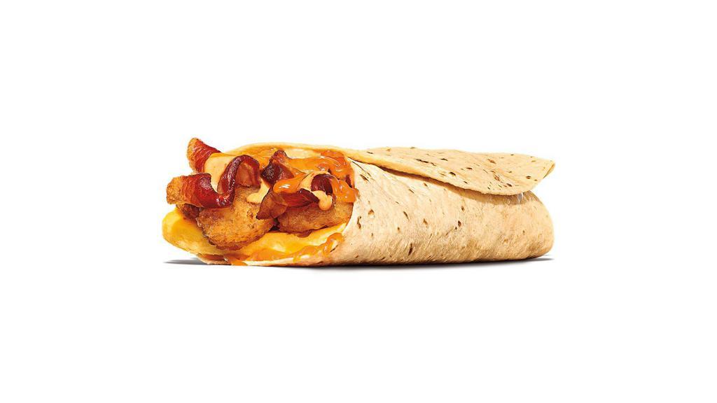 Egg-Normous Burrito™ · Featuring a generous serving of thick-cut smoked bacon, lots of fluffy eggs, topped with Queso sauce, golden hash browns, plus a creamy spicy sauce all wrapped up in a warm flour tortilla and served with a side of Picante Sauce.