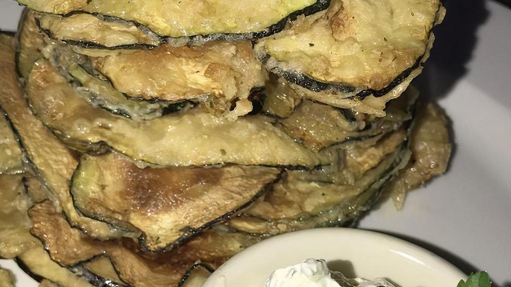 Anassa Chips · Thinly sliced zucchini and eggplant, lightly fried and served with tzatziki.