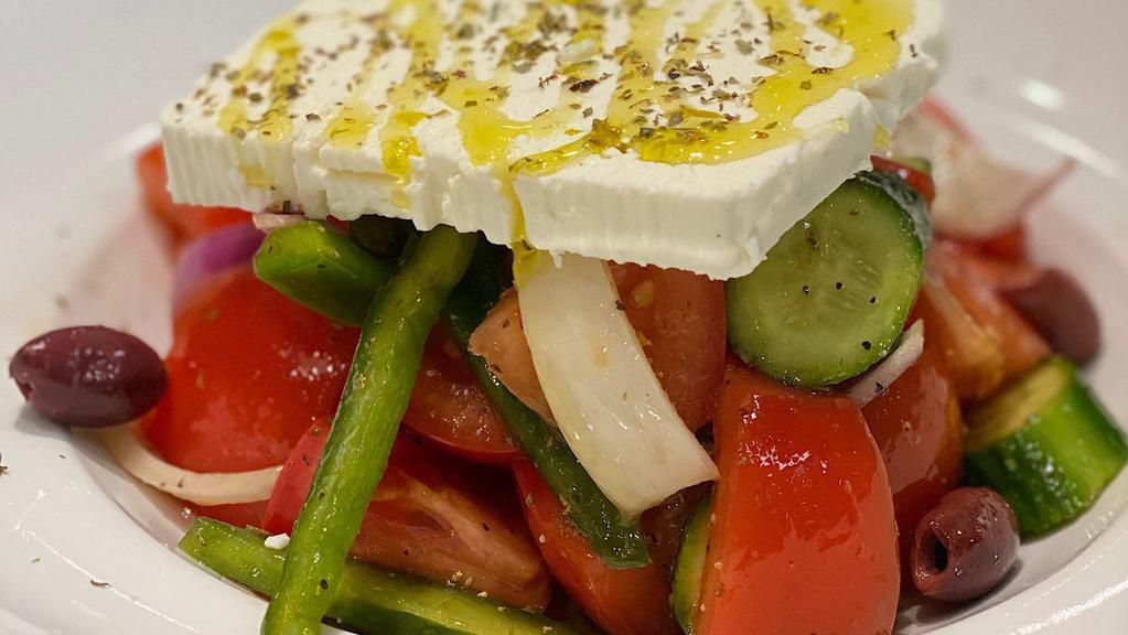 Classic Greek Salad · Tomato, cucumbers, peppers, onions, capers, Kalamata olives and feta cheese.