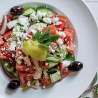 Horiatiki Salad · Vine ripe tomatoes, cucumber, red onion, peppers, olives, and Arahova feta.