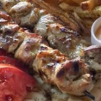 Chicken Souvlaki · Grilled skewered organic chicken, homemade honey Dijon sauce, romaine salad, tomato, Greek o...
