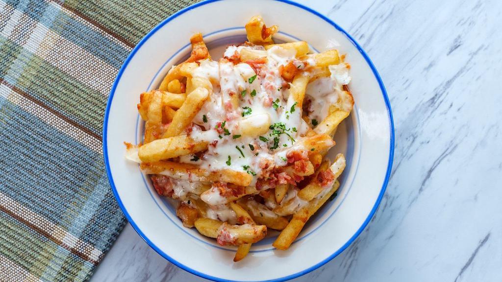 Bacon Cheese Fries · Crispy, golden, seasoned fries smothered with melty cheese and smoky, crispy bacon pieces.
