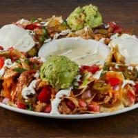 Mega-Mex Tex-Mex Chicken Nachos · More of everything, and topped. with guacamole, sour cream and jalapeños . Monterey Jack and...