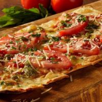 Margherita Flatbread · House-made marinara, ripe tomato, basil pesto, . mozzarella and Parmesan cheeses