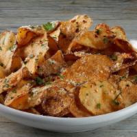 Garlic Parmesan Chips · Housemade potato chips tossed in our signature garlic Parmesan sauce