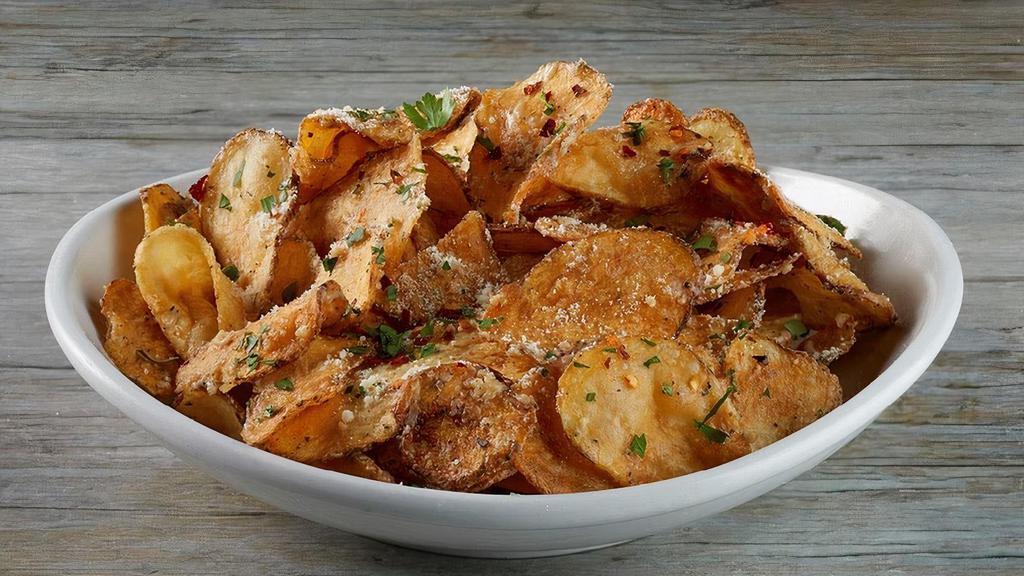 Garlic Parmesan Chips · Housemade potato chips tossed in our signature garlic Parmesan sauce