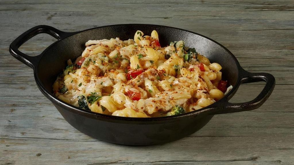 Chicken Scampi Pasta Bake · Grilled chicken breast, tomatoes, broccoli, creamy garlic scampi sauce, corkscrew pasta, topped with mozzarella, Parmesan and toasted breadcrumbs.