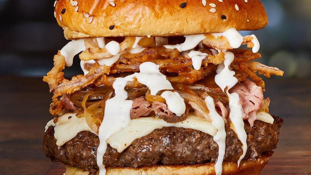Prime Burger* · Melted white American cheese, shaved prime rib, roasted mushrooms, sautéed onions, gravy, crispy onion tanglers and garlic-lime crema..