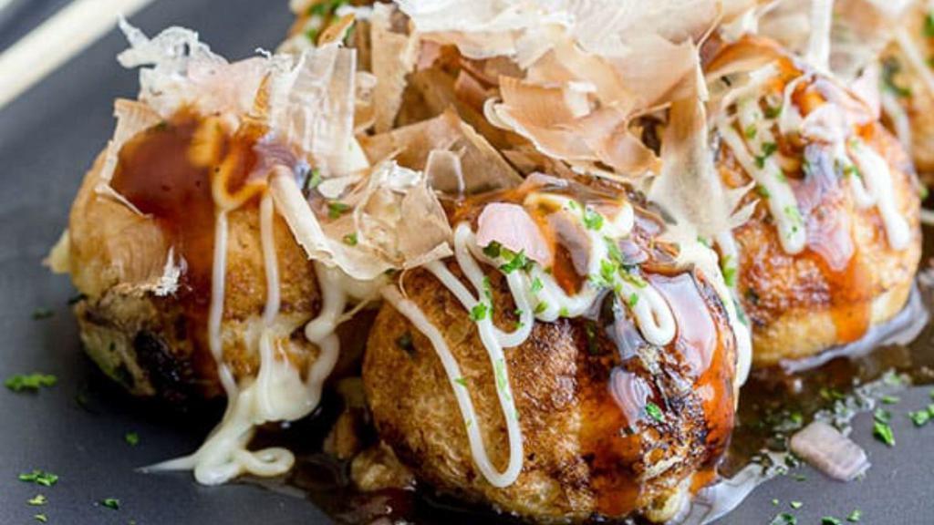 Panko Takoyaki · 4 pieces of Battered Octopus Balls with Panko Crust, Kewpie Mayo, Okonomiyaki Sauce, Smoked Bonito Flake & Fresh Green Onion.
