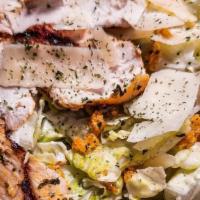 Classic Caesar Salad · Grilled chicken breast over romaine lettuce, shaved Parmesan cheese, and croutons tossed wit...