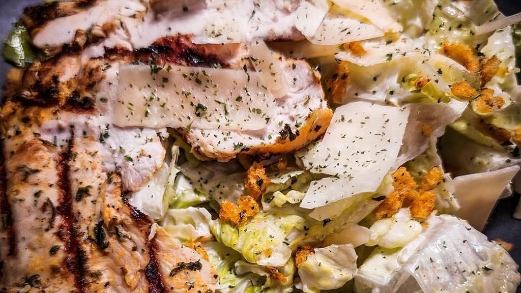 Classic Caesar Salad · Grilled chicken breast over romaine lettuce, shaved Parmesan cheese, and croutons tossed with homemade Caesar dressing.