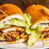 Torta Milanesa De Pollo · Made with boneless breaded chicken breast. Includes black beans, jalapeños, jack cheese, sli...