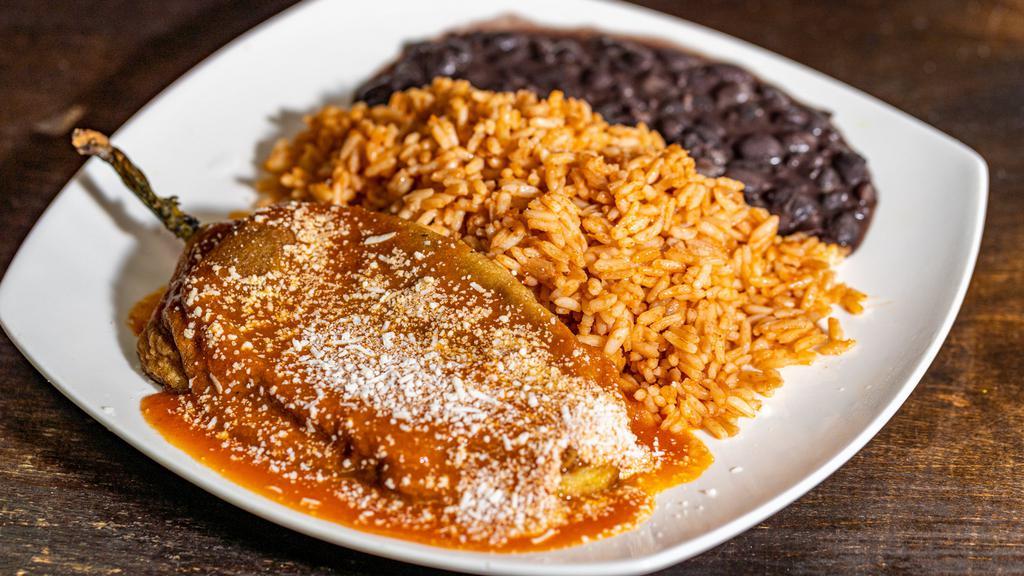 Chile Relleno · One chile poblano pepper stuffed with queso blanco and served with yellow rice and black refried beans and corn tortillas on the side.