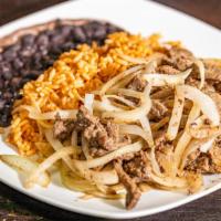 Bistec Encebollado · Grilled shredded lean steak and sautéed onions, served with yellow rice and black refried be...