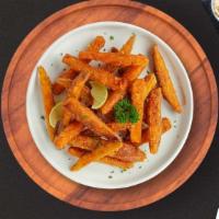 Sweet Potato Fries · Thick-cut sweet potato wedges fried until golden brown