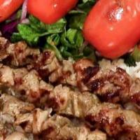 Kofta Kebab · Char grilled ground lamb patties seasoned with Turkish spices and served over rice and salad.