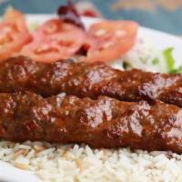 Iskender Kebab · Thinly sliced vertically grilled lamb served with yogurt and tomato garlic.