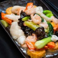 Seafood Tofu · A delicious combo of calamari, baby shrimp, fish fillet, black wood ear mushrooms, topped wi...