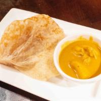 Roti Canai · Spicy. Malaysian crispy Indian style pancake. Served with curry chicken as dipping sauce.