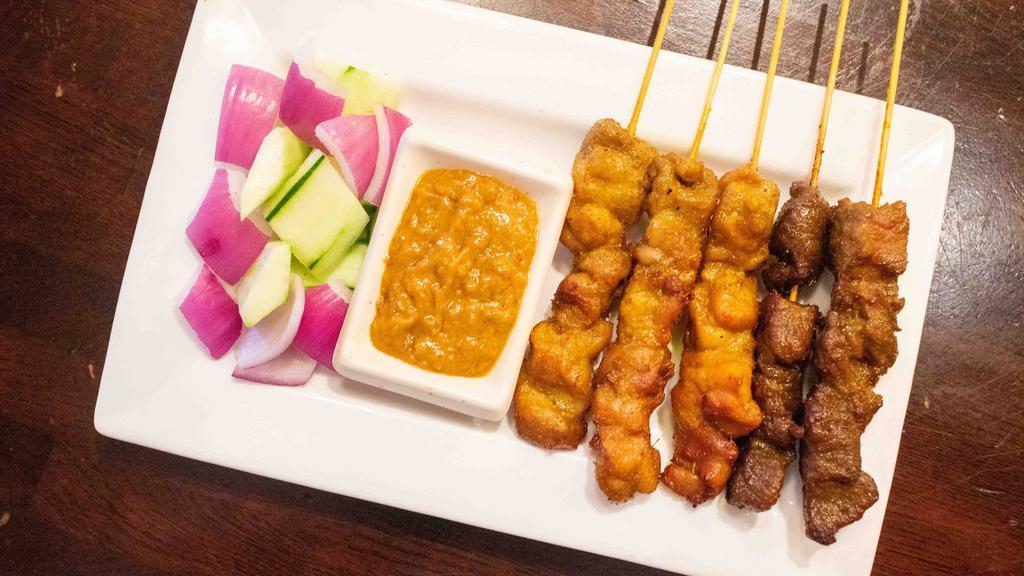 Penang Satay · Spicy. Five sticks. Marinated beef or chicken on skewers, charcoal grilled to perfection. Served with peanut sauce. Spicy.