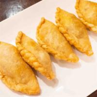 Malaysian Curry Puff · Spicy. Pastry dough stuffed with chicken, onion, potato and curry powder. Spicy.