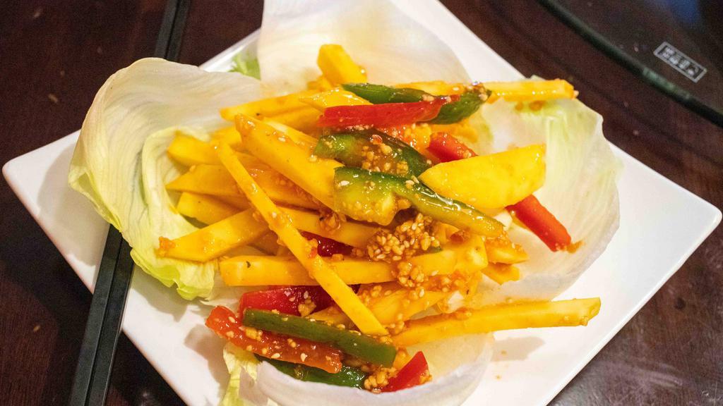Thai Mango Salad · Spicy. Shredded mango and bell pepper topped with ground peanut. Served with thai sweet and spicy sauce. Spicy.