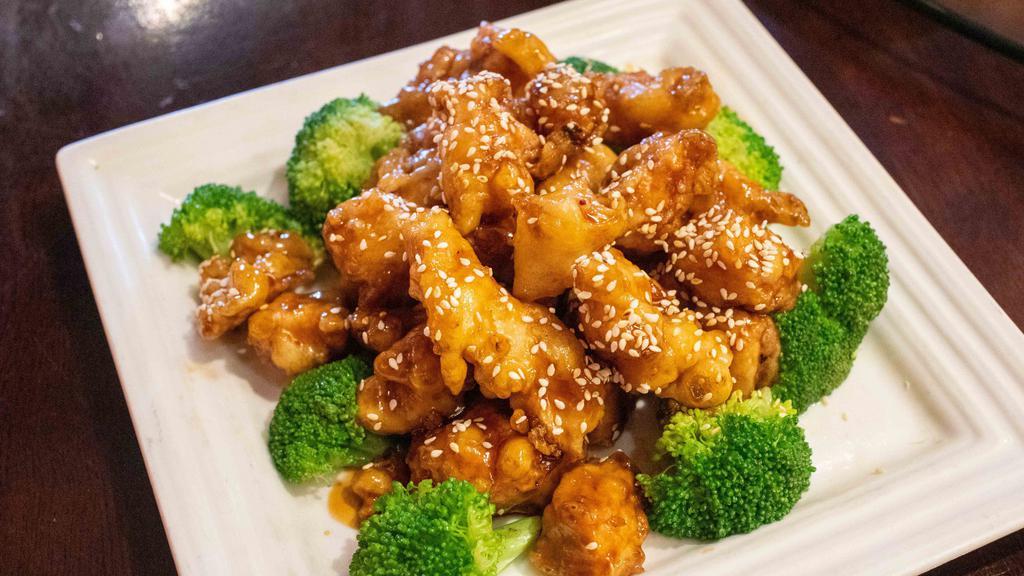 Sesame Chicken · Deep-fried white meat chicken with sesame seeds and a brown sweet and sour sauce.