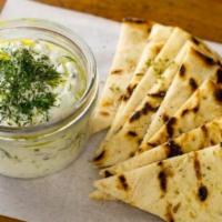 Tzatziki · Smoked eggplant dip, garlic, herbs, fire-roasted peppers, and extra virgin olive oil.