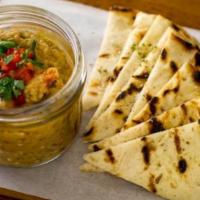 Melitzanosalata · Smoked eggplant dip, garlic, herbs, fire-roasted peppers, and extra virgin olive oil.