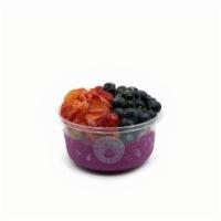 Dragonberry- Pitaya Bowl · Pitaya blend topped with granola, strawberry, blueberry, and honey.