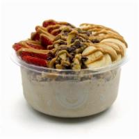 Nica Bowl · Banana blend topped with granola, banana, cacao nibs, walnuts, strawberry, peanut butter.
