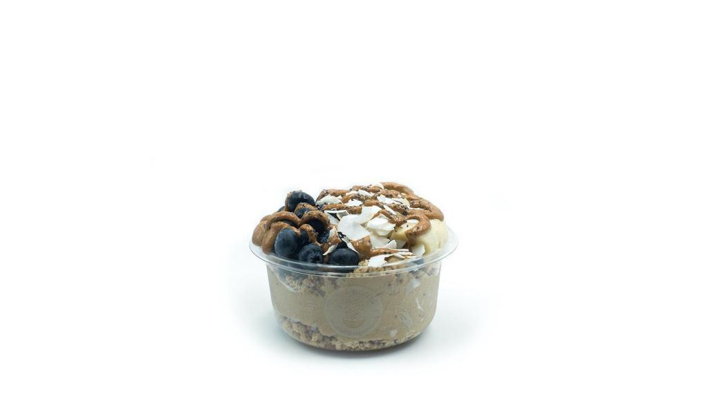 Olas- Banana Bowl · Banana blend topped with granola, banana, blueberry, coconut flakes, chia seeds, and almond butter.