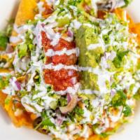 Katch Nachos · Fried corn tortillas smothered in pepper jack cheese sauce with black beans, pico de gallo, ...