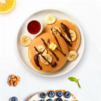 Wanna Banana Nutella Pancakes · Fluffy banana nutella pancakes cooked with care and love served with butter and maple syrup....