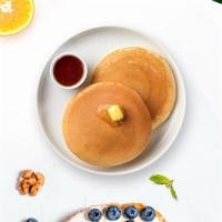 Classic Pancakes · Three fluffy pancakes served with butter and maple syrup.