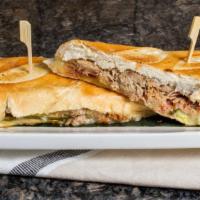Cuban Sandwich  · Roasted pork ,Swiss cheese, ham, pickles and mustard on Cuban bread.