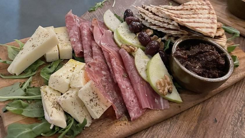 Charcuterie And Cheese · Prosciutto, salami, graviera, brie, toasted bread, fig sauce, pistachio and Kalamata olives.