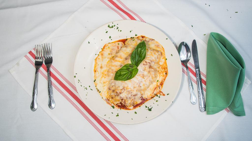Chicken Parmigiana · Breaded chicken tossed in marinara sauce and covered with cheese.