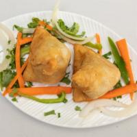 Vegetable Samosa · Crispy turnover, delicious filled with mildly spices potatoes and green peas.