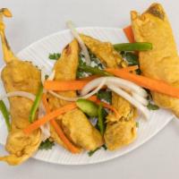 Hari Mirchi Bhajia · Fresh green chilis stuffed with potato spicy mixture and dipped in a batter and fried, serve...